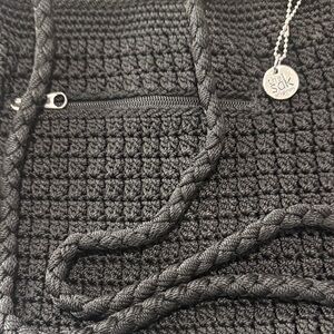 The Sak Black Crochet Hobo with Braided Straps and Logo Charm